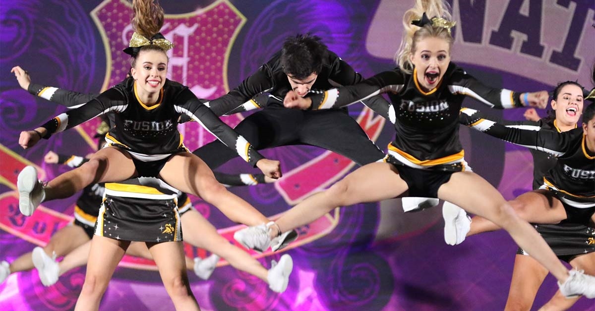 Cheerleaders doing a pike jump in a routine
