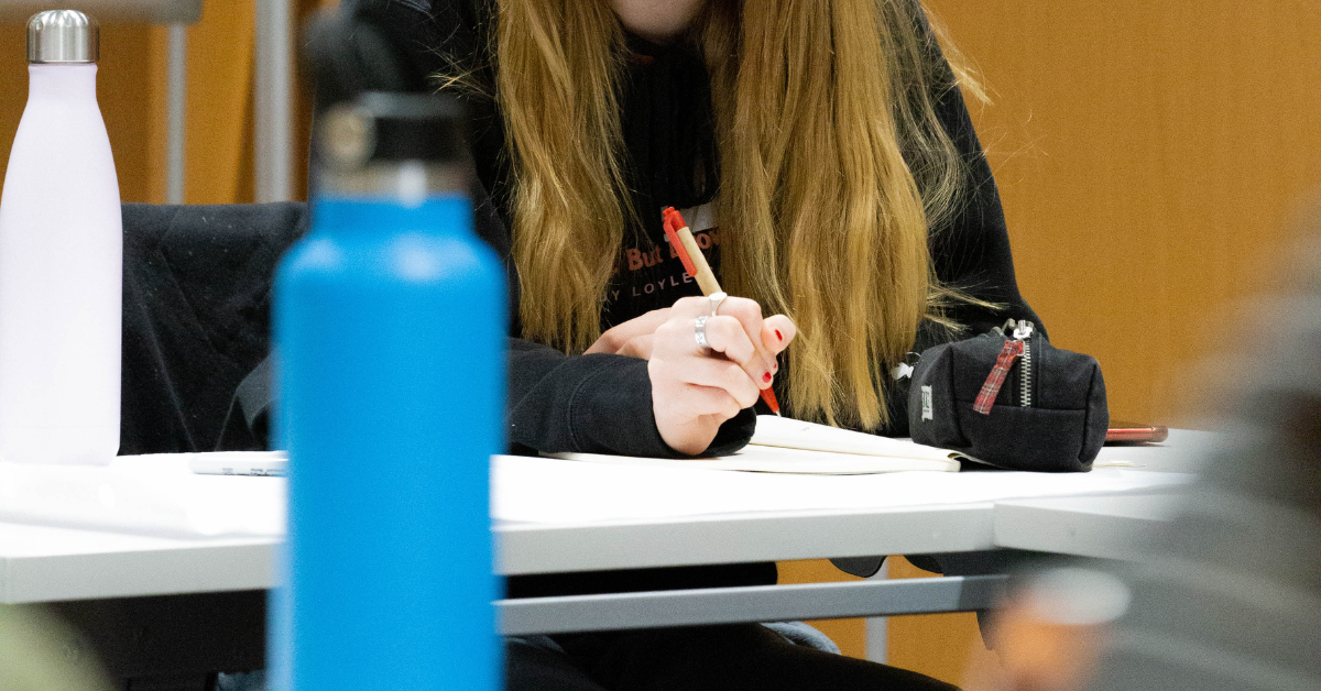 A student writing down notes at The Big Rep Meeting