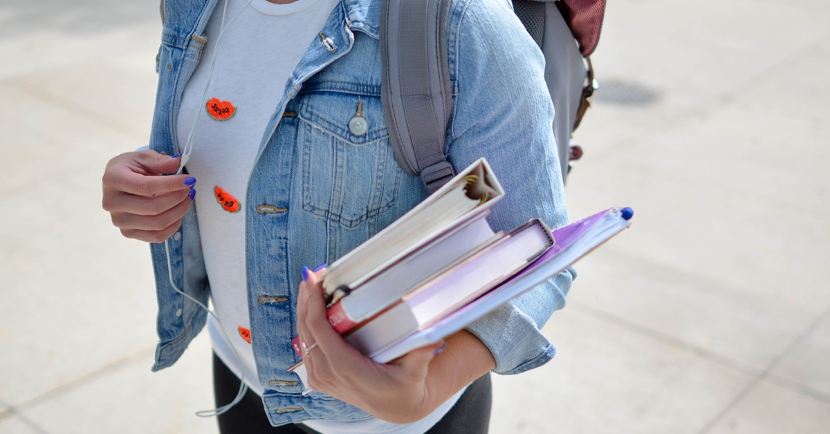 Student carrying books and notes