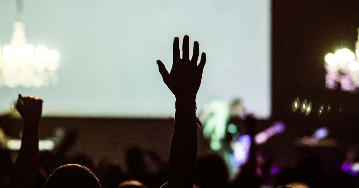 Somebody raising their hand at a conference