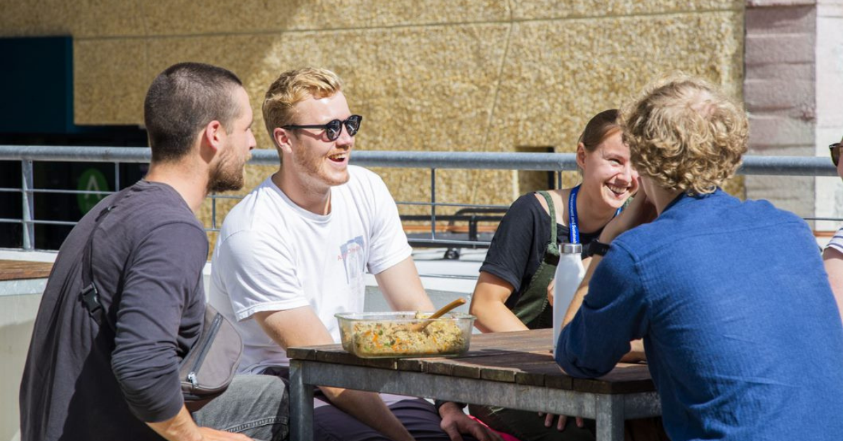 Students chatting in the sunshine during welcome week.