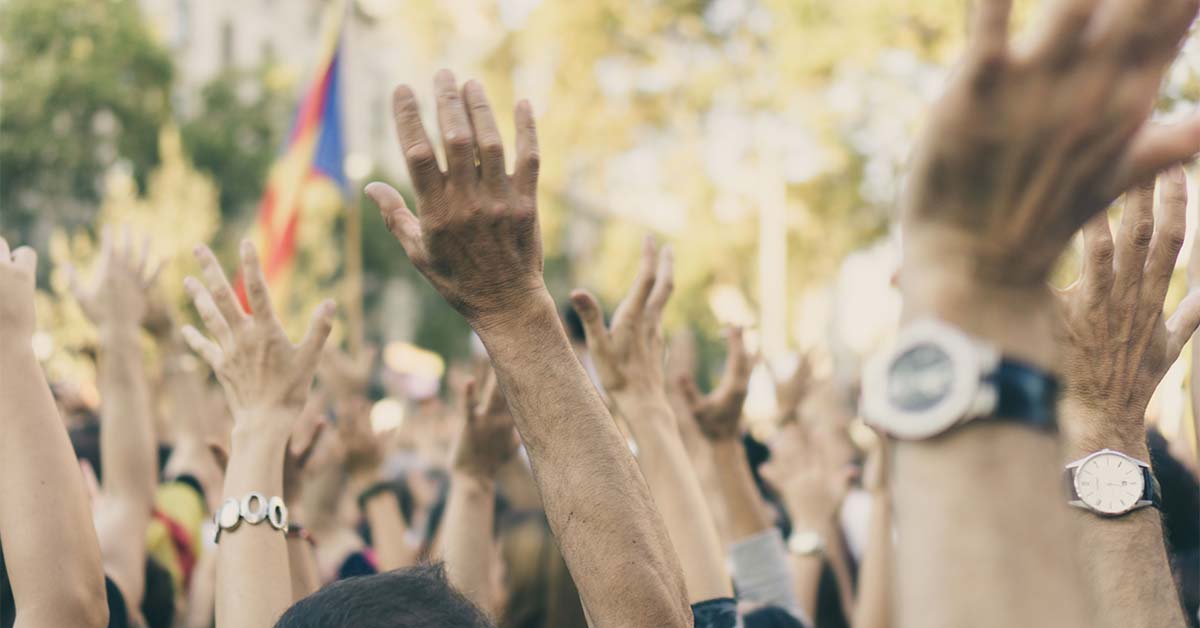 Students with their hands all in the air at a demonstration