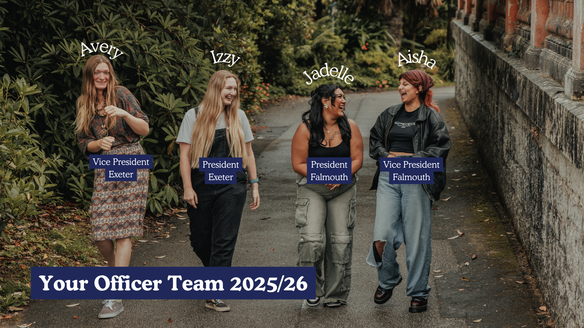 A photo of SU Presidents 2025/26 - Avery, Izzy, Jadelle and Aisha. They are laughing and walking along a paved path with a wall on the right hand side of them and shrubbery on the left.
