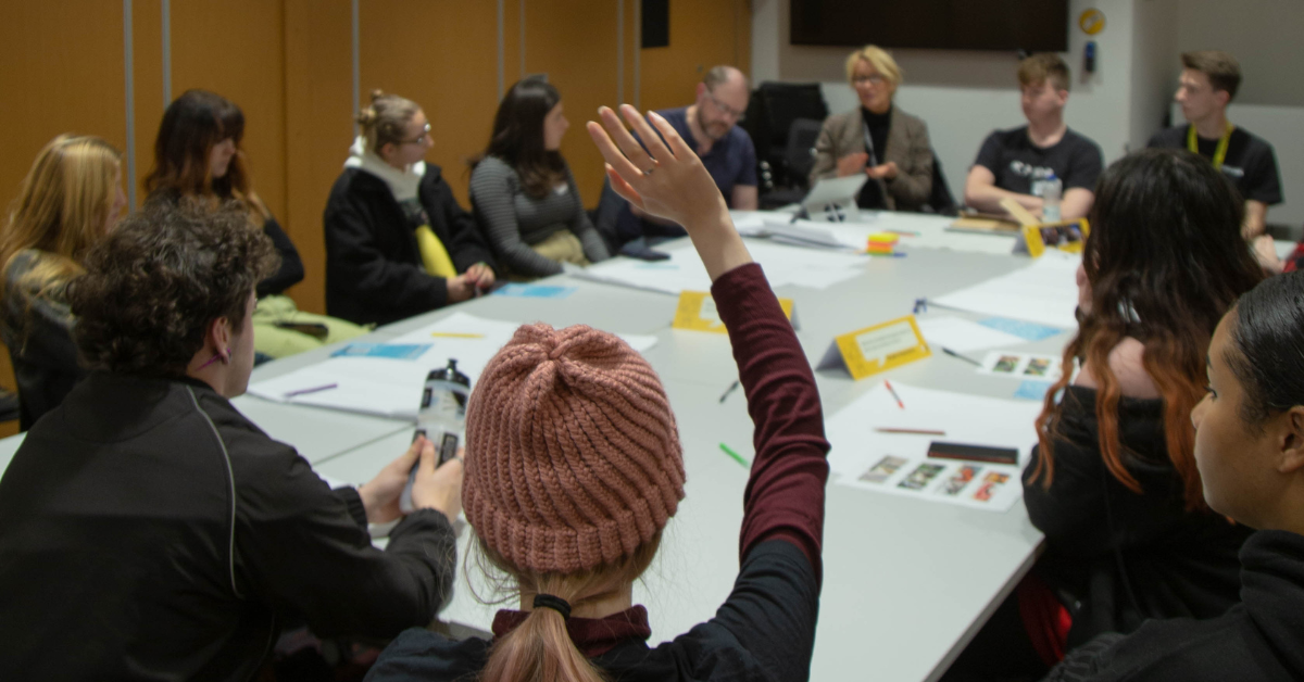 Students talking and taking notes at The Big Rep Meeting